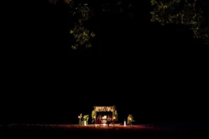 a couple having candle light dinner by the beach