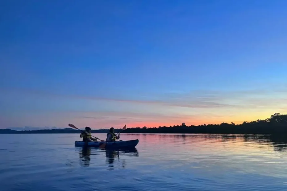 two girls on a kayak watching sunset