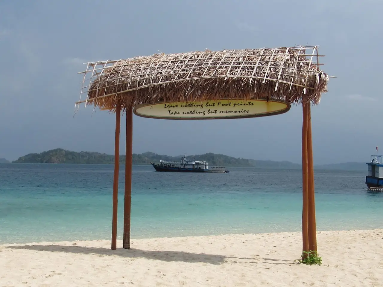 A large wooden arch on the beach of Jolly Buoy Island