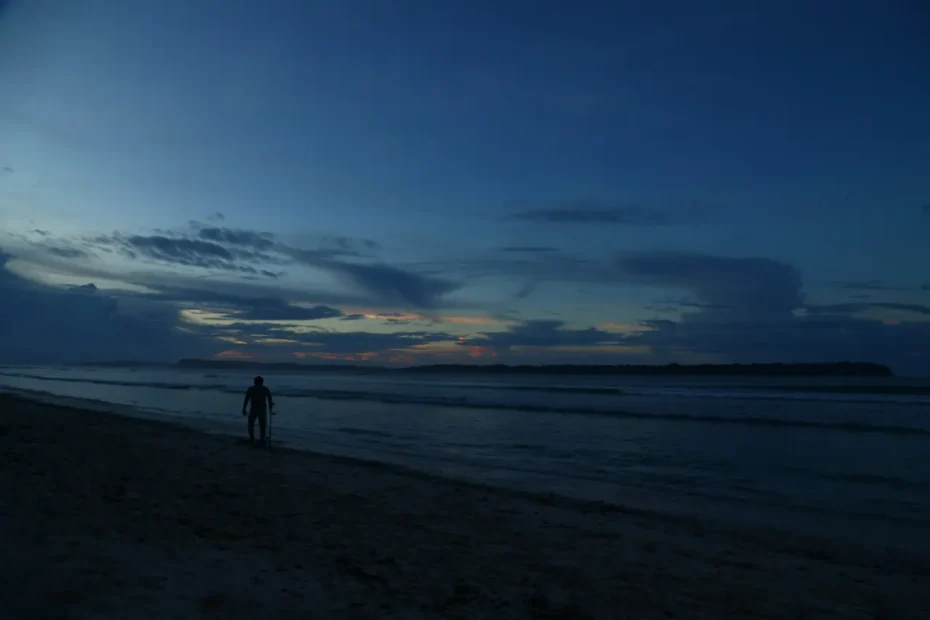 Sunrise at a beach with a man standing